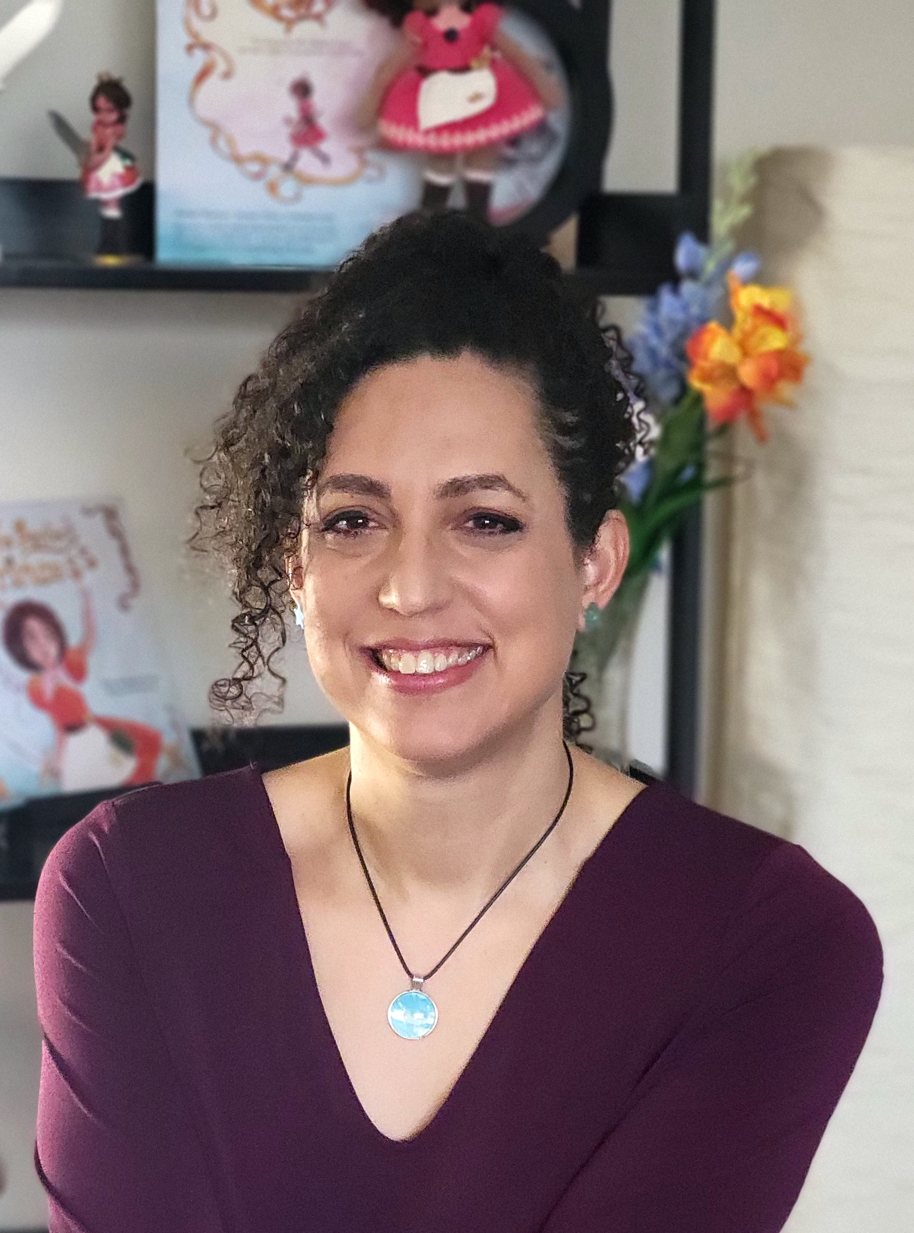 The book's author and painter, Bambi Nieves wearing a dress with pictures of dogs on it